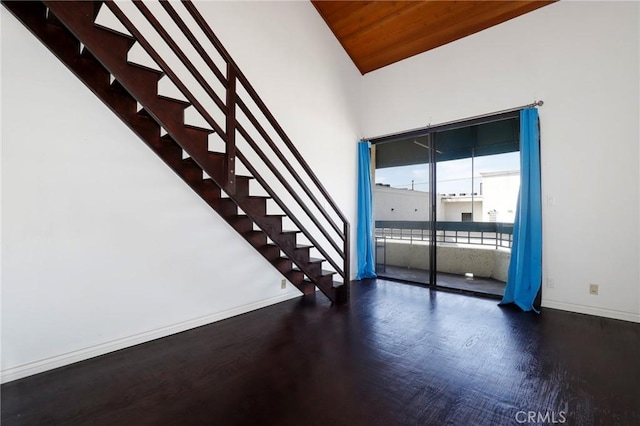 435 S La Fayette Park Pl Unit 311, Los Angeles, CA 90057 - unfurnished room featuring wood finished floors, stairway, baseboards, a towering ceiling, and wooden ceiling