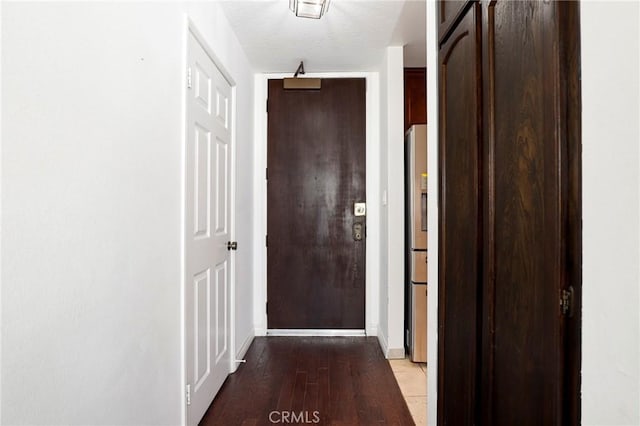 hall featuring baseboards and wood finished floors