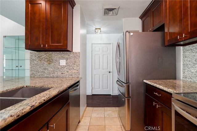 435 S La Fayette Park Pl Unit 311, Los Angeles, CA 90057 - kitchen featuring stainless steel appliances, tasteful backsplash, light stone counters, and light tile patterned flooring