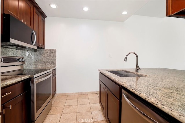 435 S La Fayette Park Pl Unit 311, Los Angeles, CA 90057 - kitchen featuring stainless steel appliances, a sink, light stone counters, tasteful backsplash, and recessed lighting