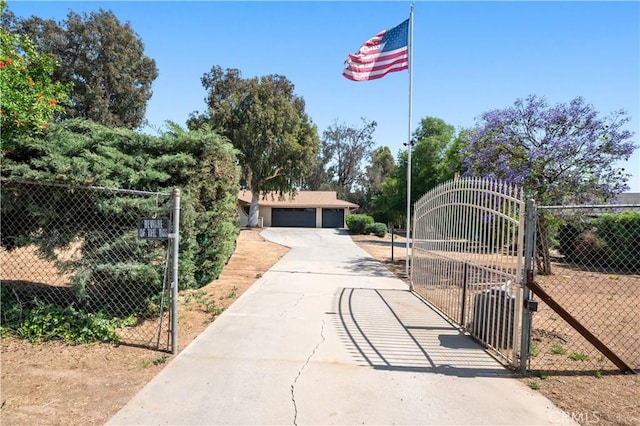 exterior space with a gate, fence, and a detached garage