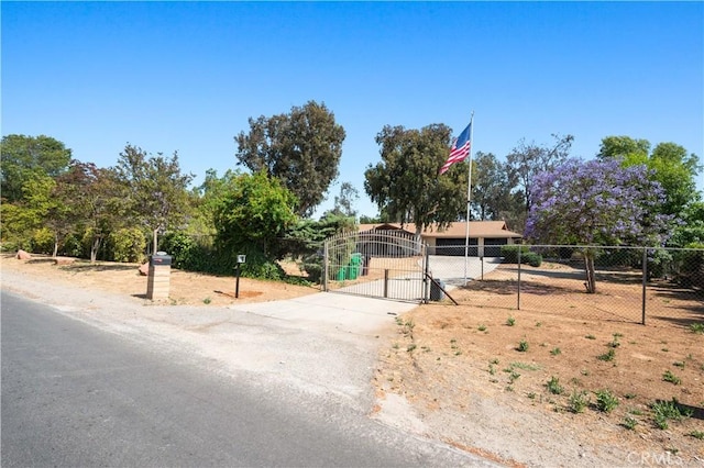 ranch-style home featuring fence and a gate