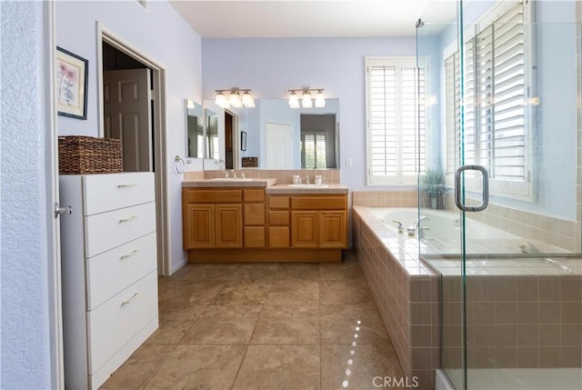 bathroom featuring double vanity, a stall shower, a sink, and a bath