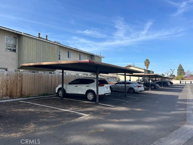 partially covered parking lot with fence