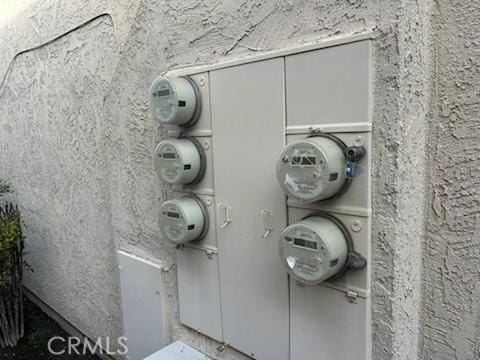 exterior details with electric meter and stucco siding