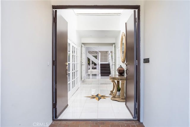 hall featuring stairs, french doors, and tile patterned flooring