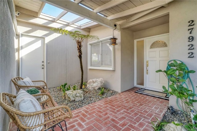 entrance to property featuring stucco siding