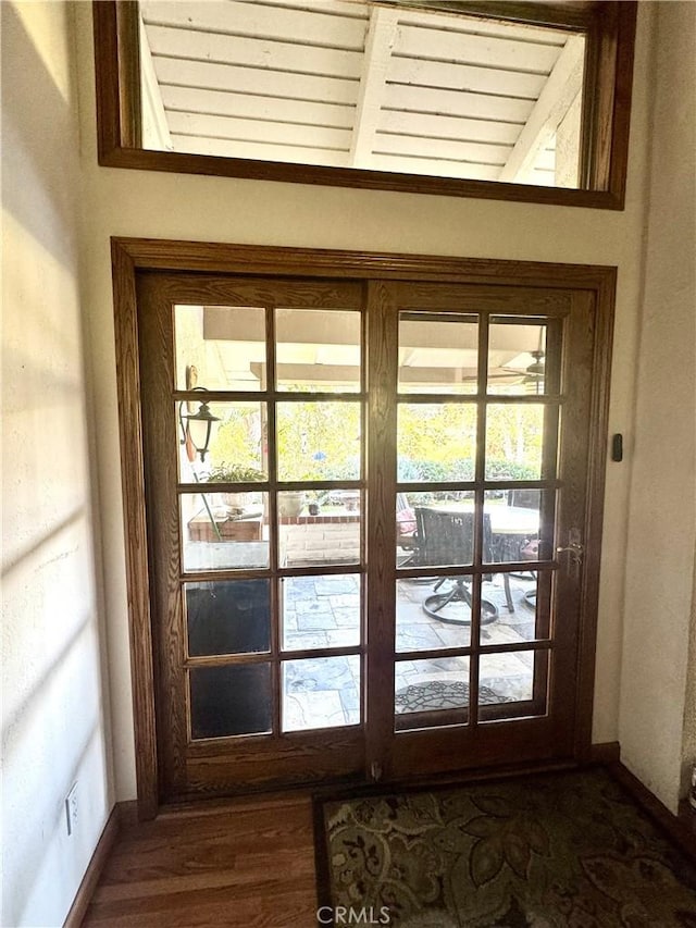 entryway featuring dark wood-style flooring and baseboards