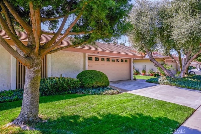 712 Via Zapata, Riverside, CA 92507 - view of front of home featuring stucco siding, an attached garage, a front yard, driveway, and a tiled roof