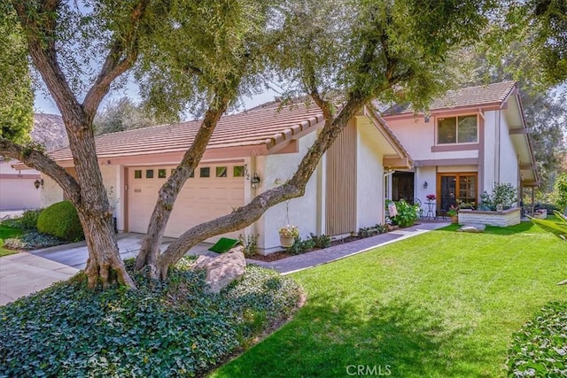 712 Via Zapata, Riverside, CA 92507 - view of front of house with a front lawn, an attached garage, stucco siding, a tile roof, and concrete driveway