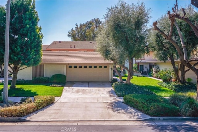 712 Via Zapata, Riverside, CA 92507 - view of front facade featuring a tiled roof, stucco siding, an attached garage, concrete driveway, and a front lawn