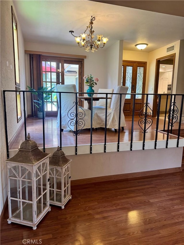 712 Via Zapata, Riverside, CA 92507 - stairs featuring a chandelier, wood finished floors, and baseboards