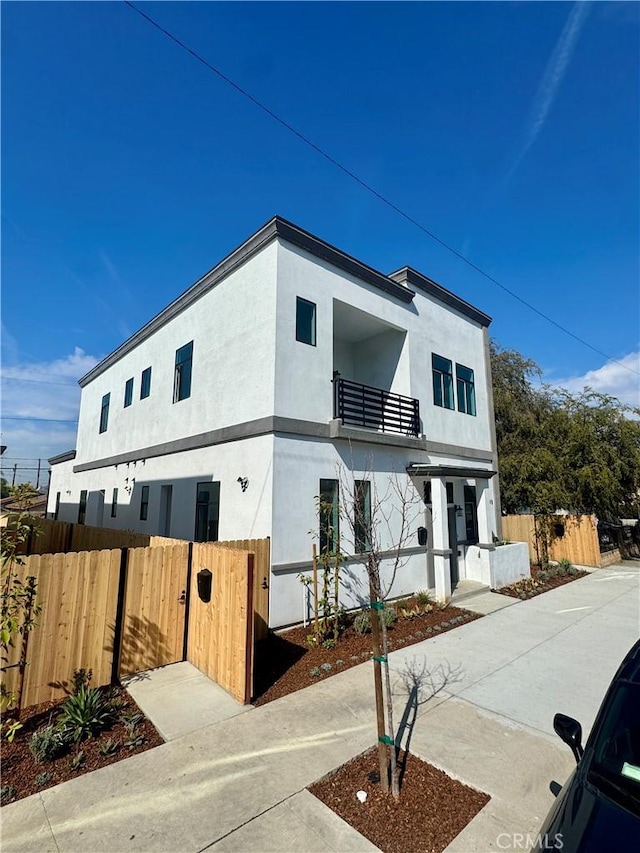 view of front of property with fence and stucco siding