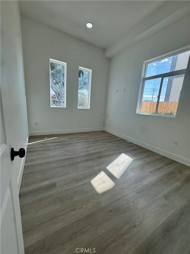 empty room with baseboards and wood finished floors