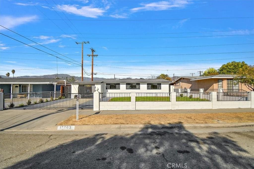 ranch-style home with a fenced front yard