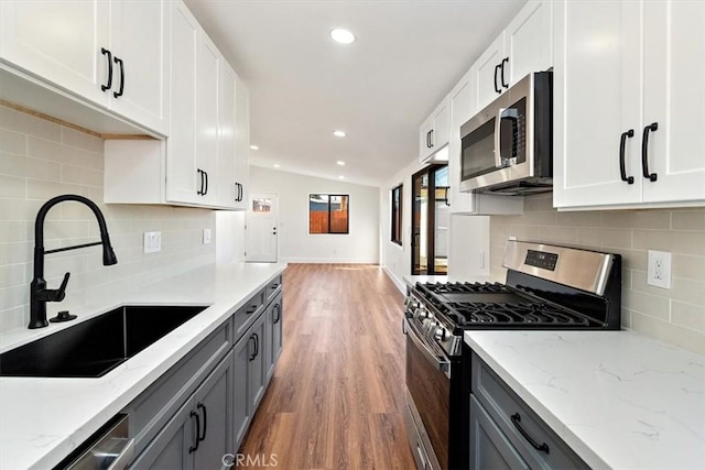 kitchen featuring white cabinetry, stainless steel appliances, and a sink