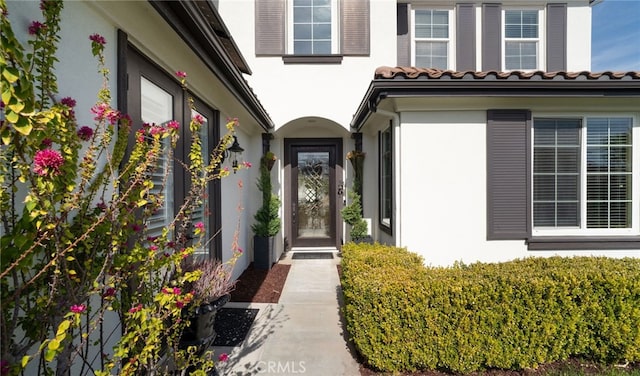 entrance to property with stucco siding