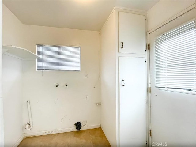 clothes washing area with light tile patterned floors and laundry area