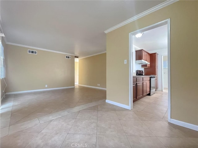 empty room featuring visible vents, crown molding, baseboards, and light tile patterned floors