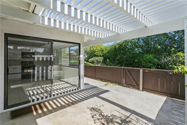 view of patio featuring fence and a pergola