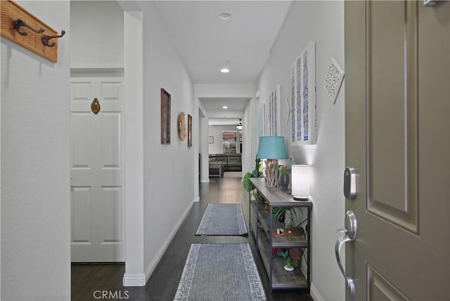 corridor featuring recessed lighting, baseboards, and wood finished floors