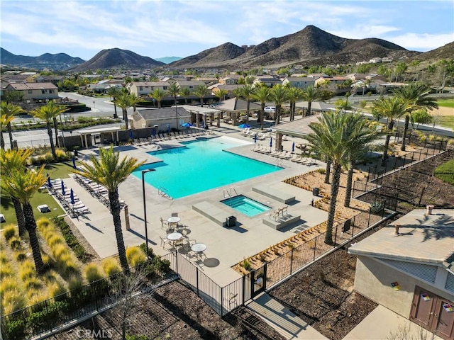 pool featuring a mountain view and fence