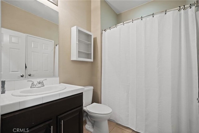 bathroom featuring vanity, toilet, and tile patterned floors