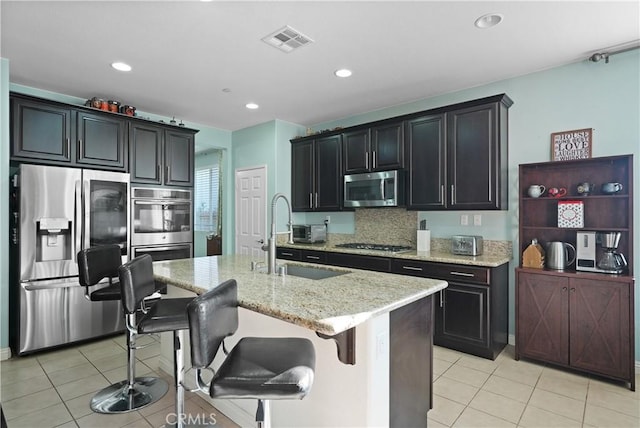 34306 Deergrass Way, Lake Elsinore, CA 92532 - kitchen with light tile patterned flooring, appliances with stainless steel finishes, a sink, and visible vents