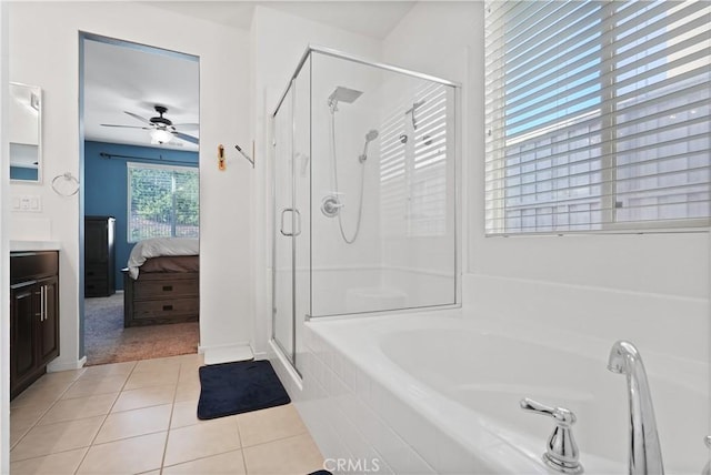 ensuite bathroom with tile patterned flooring, vanity, a bath, and a shower stall