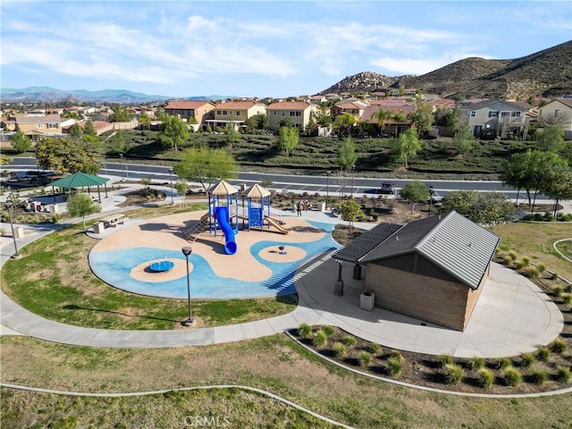 view of community featuring a mountain view, playground community, and a residential view