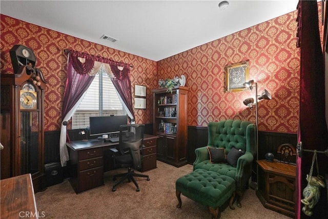 office area featuring wallpapered walls, carpet, visible vents, and a wainscoted wall