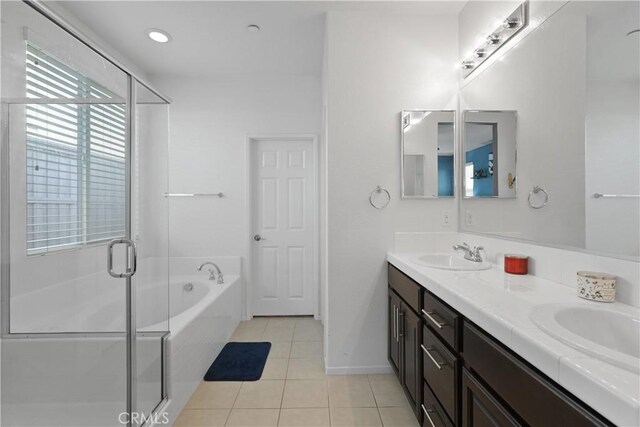 34306 Deergrass Way, Lake Elsinore, CA 92532 - bathroom with a sink, double vanity, tile patterned floors, a garden tub, and a stall shower