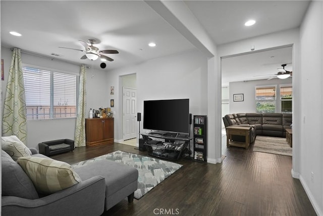 living area with recessed lighting, wood finished floors, visible vents, and baseboards