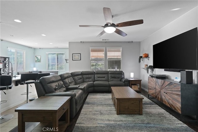 living area with ceiling fan, baseboards, visible vents, and recessed lighting