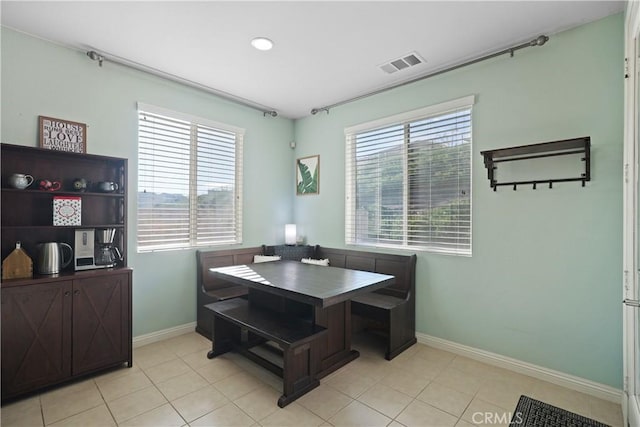 dining space with visible vents, baseboards, and light tile patterned floors