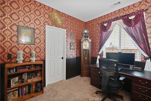 home office with carpet floors, wainscoting, visible vents, and wallpapered walls