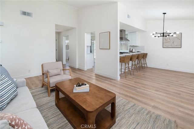 7969 Calle Madrid, Carlsbad, CA 92009 - living area with a chandelier, light wood-style flooring, and baseboards
