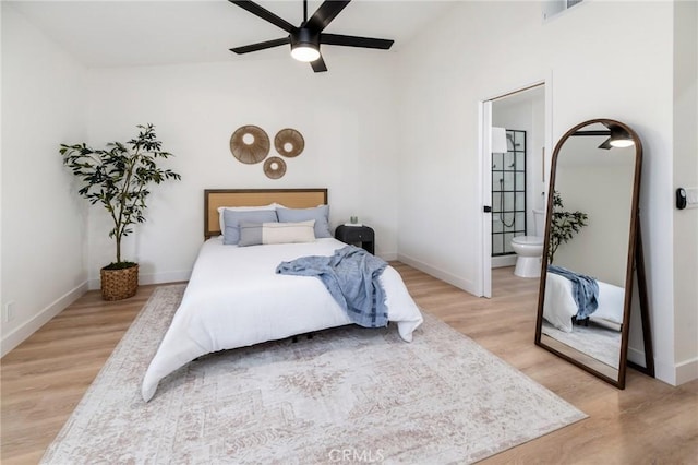 7969 Calle Madrid, Carlsbad, CA 92009 - bedroom with light wood-style floors, lofted ceiling, baseboards, and ensuite bathroom