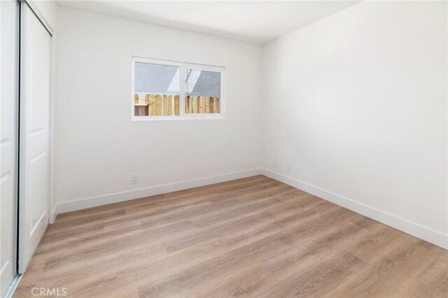 7969 Calle Madrid, Carlsbad, CA 92009 - unfurnished bedroom with a closet, light wood-style floors, and baseboards