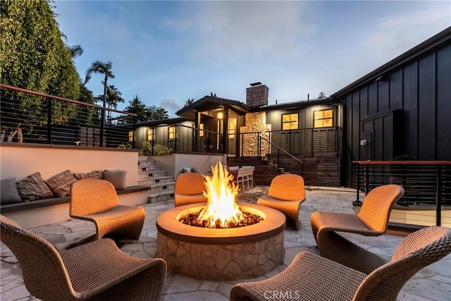 view of patio with an outdoor fire pit and stairway