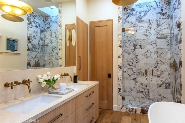 bathroom with double vanity, a marble finish shower, backsplash, and a sink