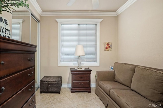 living area with light tile patterned floors, ornamental molding, and baseboards