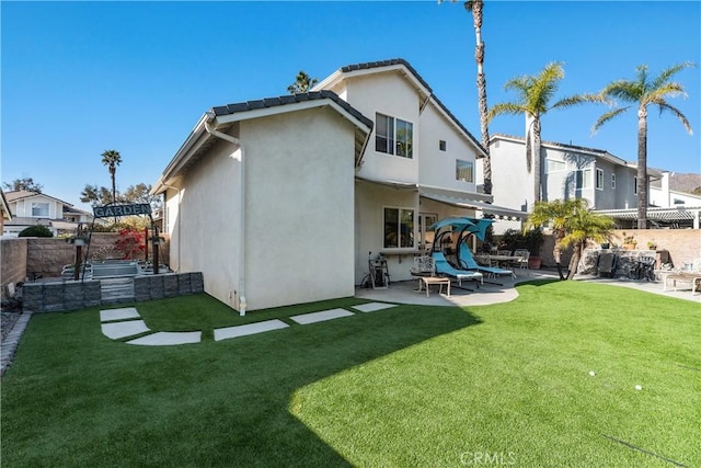 back of property featuring a patio area, a fenced backyard, stucco siding, and a yard