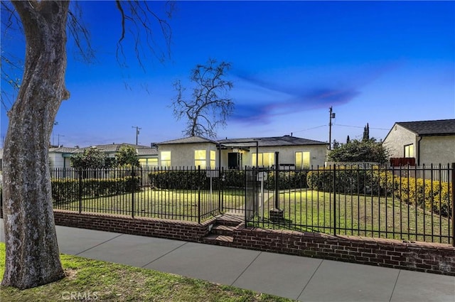 view of front facade featuring a fenced front yard, a front lawn, and stucco siding