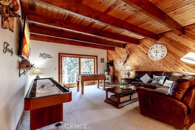 living room featuring wooden ceiling, wood walls, beam ceiling, and carpet flooring