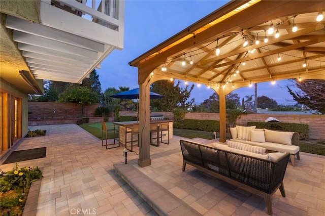 view of patio with a fenced backyard, an outdoor hangout area, and a gazebo