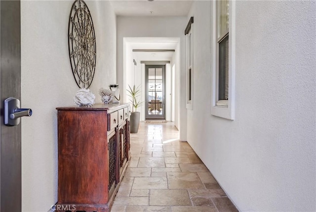 hallway featuring stone tile floors