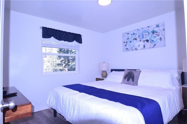 bedroom with dark wood-style floors