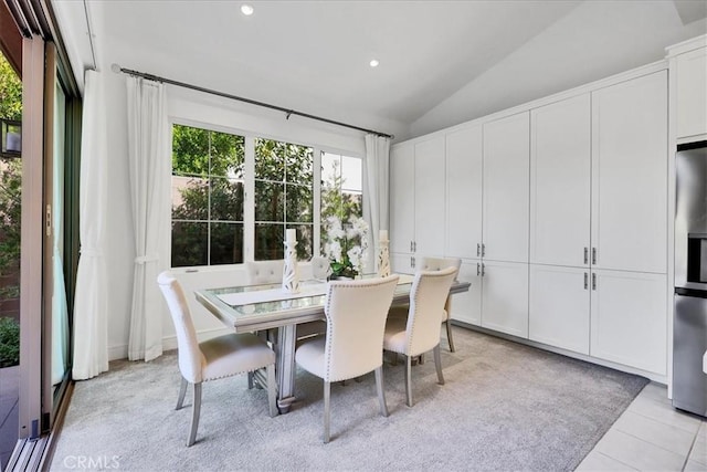 dining area with recessed lighting, vaulted ceiling, and light tile patterned floors