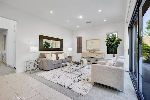 living area with light tile patterned floors, baseboards, visible vents, and recessed lighting